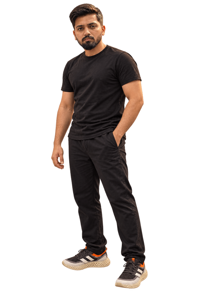 Aamir Sayyed, standing, in a black T-shirt and black trousers.